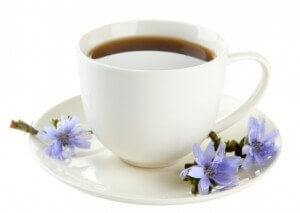 Cup of tea with chicory, isolated on white